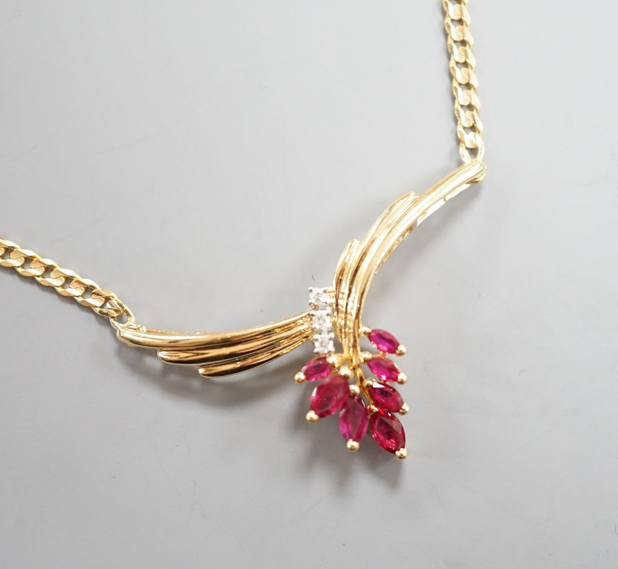 A modern 585 yellow metal, ruby and diamond cluster set pendant necklace, 44cm